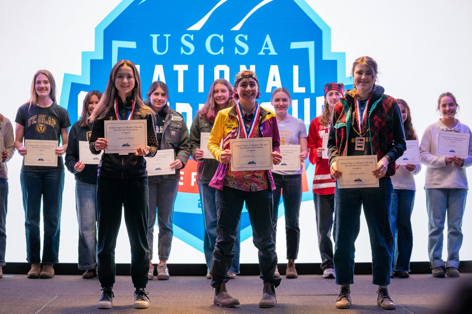 Greta Bochenek (center) stands atop the podium as national champion in the 7.5K classic at the USCSA National Championships in Lake Placid, joined by fellow All-Americans in a deep and competitive field.