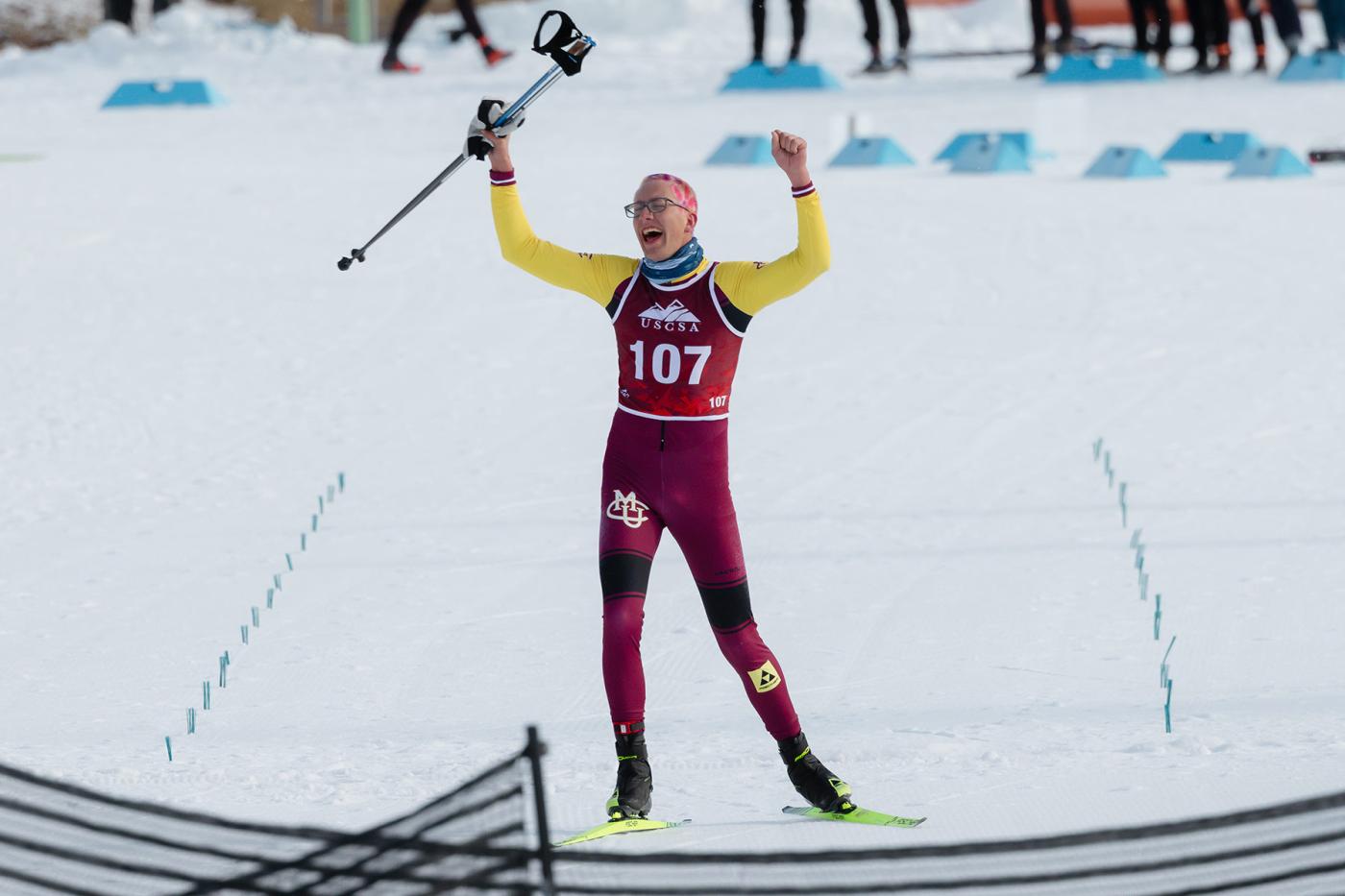 Wesley Sumner of Colorado Mesa University celebrates crossing the finish line alone to win the 15 km freestyle national title at USCSA Championships in Lake Placid.
